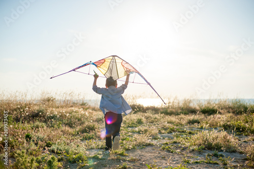Bilde på lerret brave new world concept of little active sport boy running with kite above his h