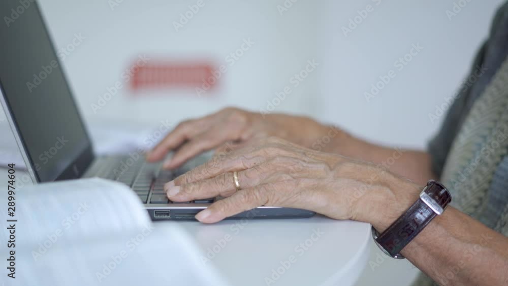 JAKARTA, Indonesia - September 10, 2019: Closeup of senior man hand working with a laptop computer on the table. Shot in 4k resolution JAKARTA, Indonesia - September 10, 2019: Closeup of senior man hand working with a laptop computer on the table. Shot in 4k resolution
