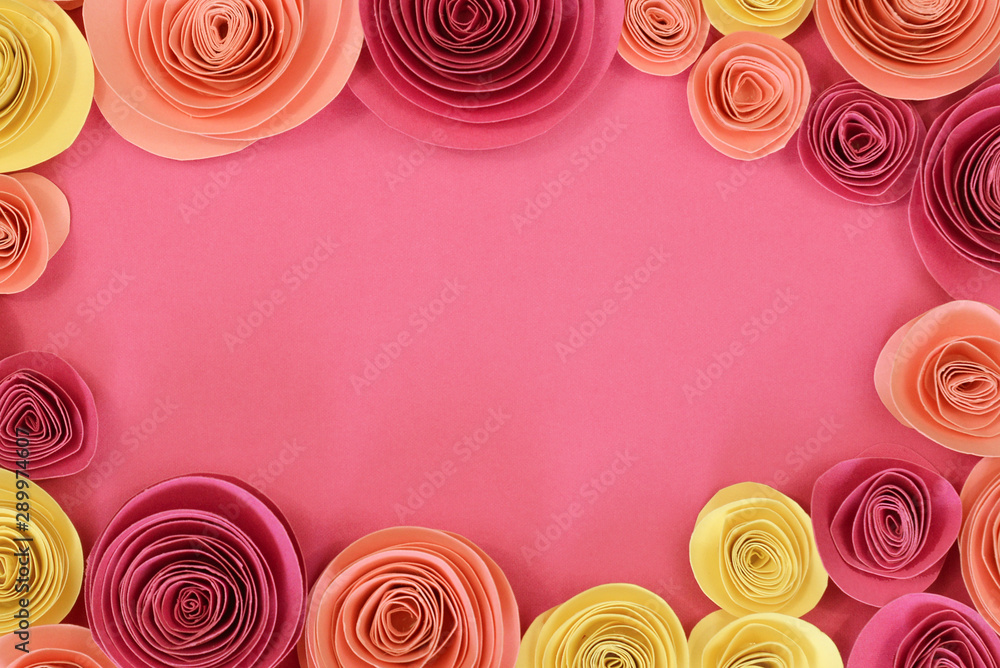 Pastel pink, magenta and yellow paper rose flat lay background with flowers around the endges and empty copy space in middle - obrazy, fototapety, plakaty 
