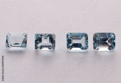 Natural faceted blue aquamarine on the white background