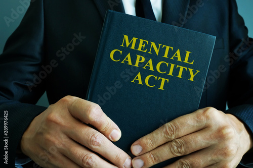 Man is holding mental capacity act.