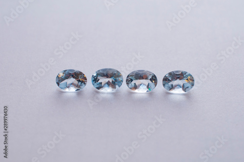 Natural faceted blue aquamarine on the white background © Galka3250