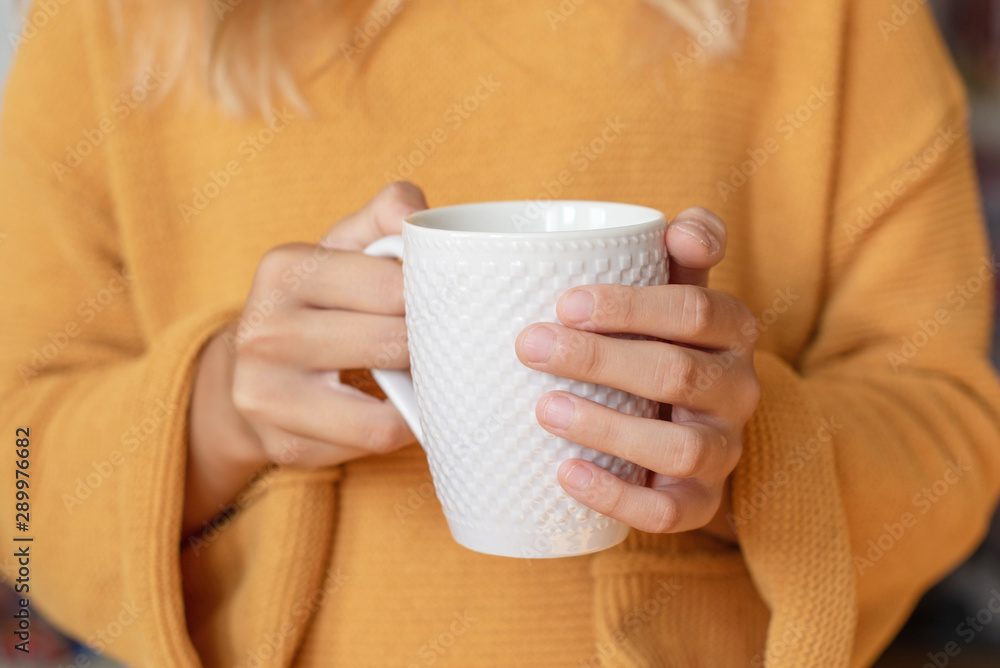 cosy autumn - cup of tea in girl's hands and autumn leaves cosy autumn - cup of tea in girl's hands and autumn leaves
