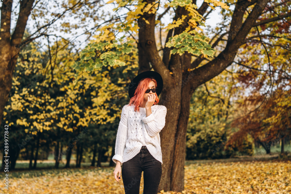 Pretty girl with red hair and hat relaxing in the park, autumn time. Pretty girl with red hair and hat relaxing in the park, autumn time.