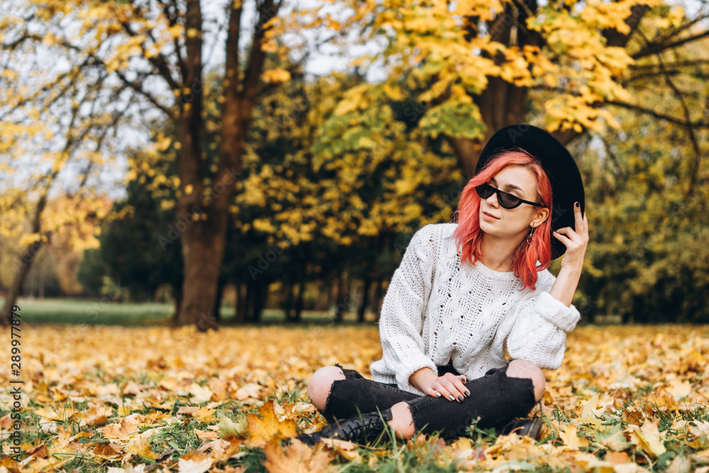 Pretty girl with red hair and hat relaxing in the park, autumn time. Pretty girl with red hair and hat relaxing in the park, autumn time.