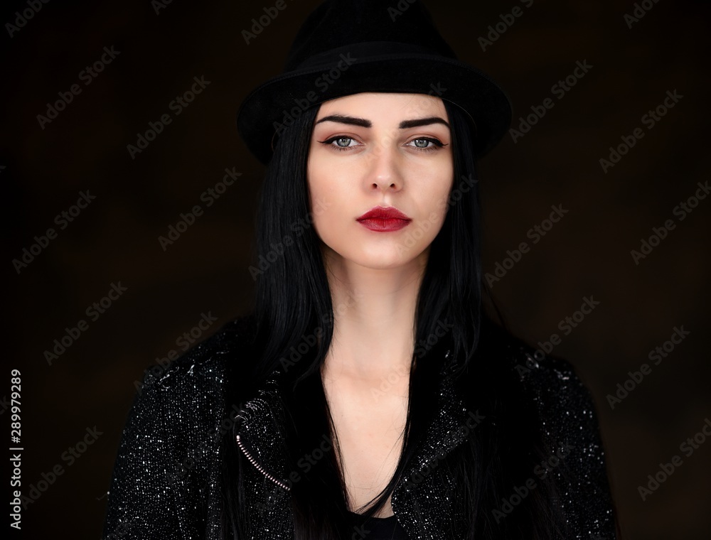 Concept close-up portrait of a pretty brunette girl in a hat on a colorful background in the studio. Concept close-up portrait of a pretty brunette girl in a hat on a colorful background in the studio.