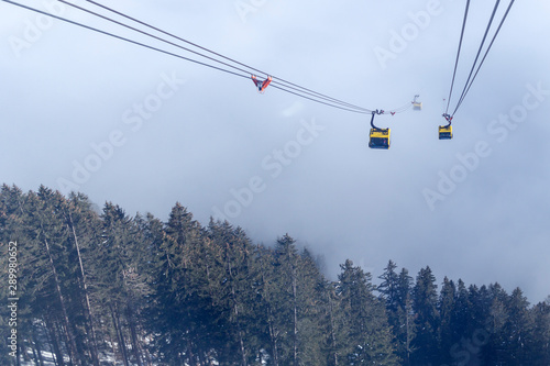 A river of white fog in the mountains and a ski lift in the foreground. Selective focus in the background.Alpine Alps mountain landscape at Tirol, Top of Europe