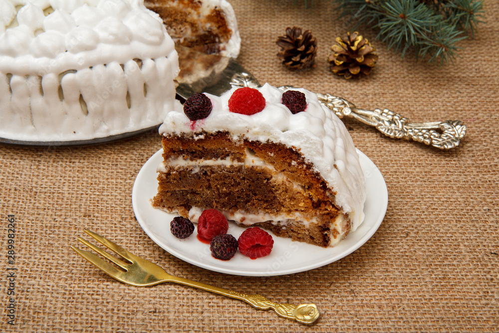 Sliced biscuit cake decorated with whipped cream and raspberries Sliced biscuit cake decorated with whipped cream and raspberries