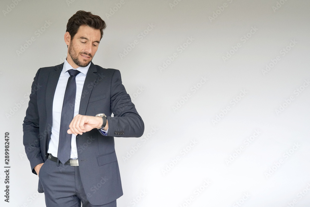 Businessman on white background, checking time Businessman on white background, checking time