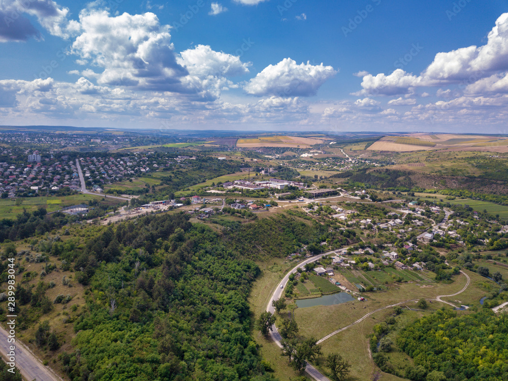Aerial view over a small village and agricultural fields