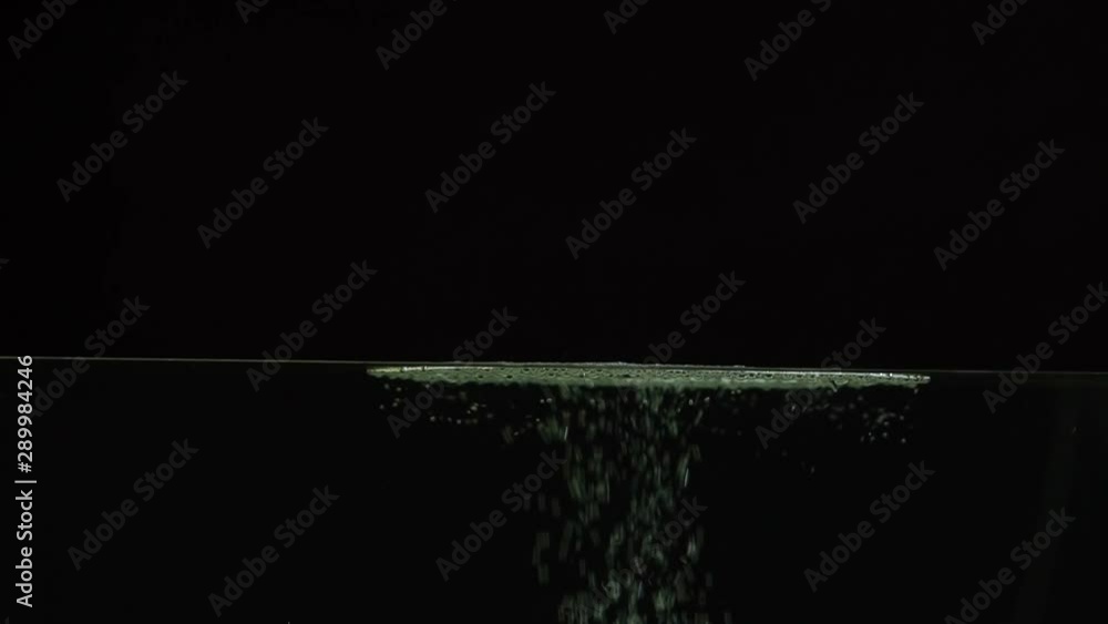 Air bubbles beautifully float to the surface of the water on a black background, splash screen, time lapse, close-up Air bubbles beautifully float to the surface of the water on a black background, splash screen, time lapse, close-up