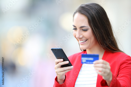 Free Download Happy woman buying on line with phone and credit card - GFXLoad