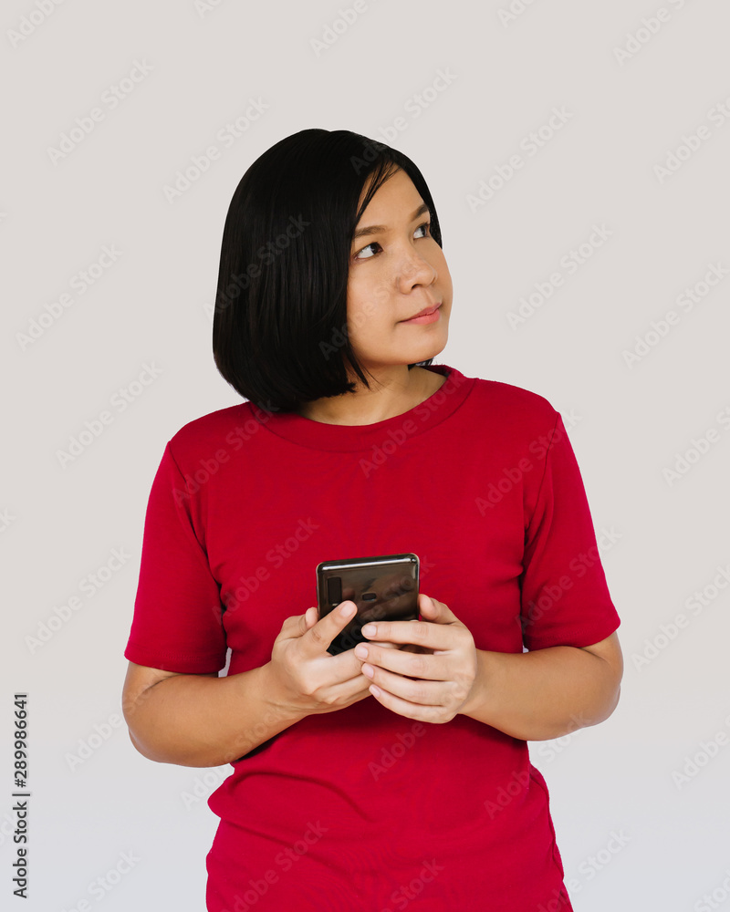 Happy woman is thinking with smartphone on white background Happy woman is thinking with smartphone on white background