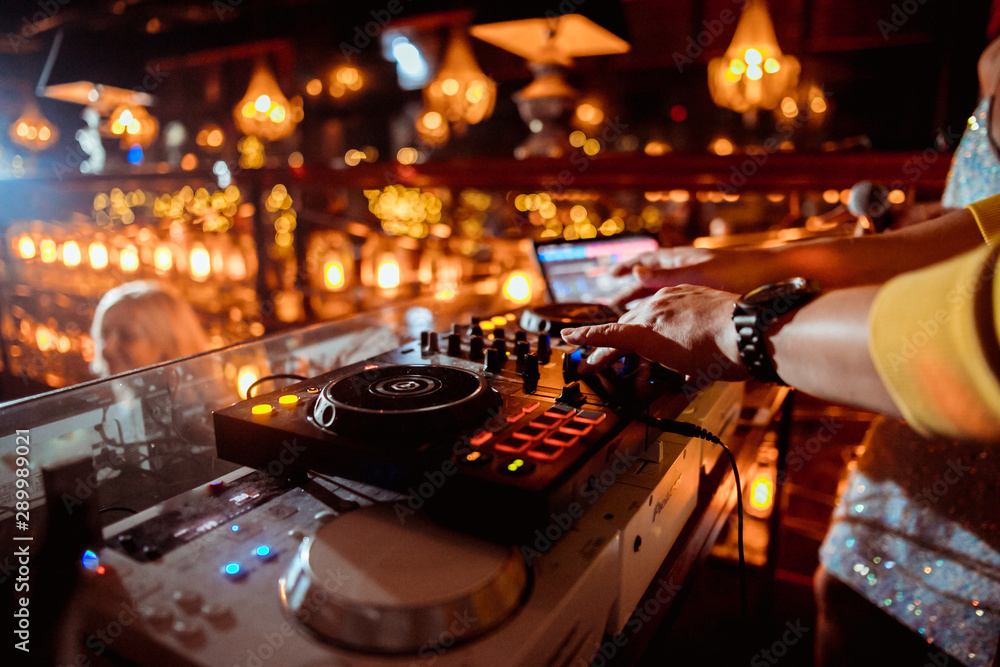 music controller DJ in the booth on the background of the dance floor with  dancing people at the party Stock Photo | Adobe Stock