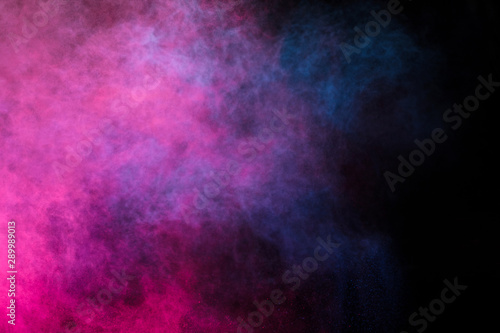 Freeze motion of colored dust explosion isolated on black background. photo