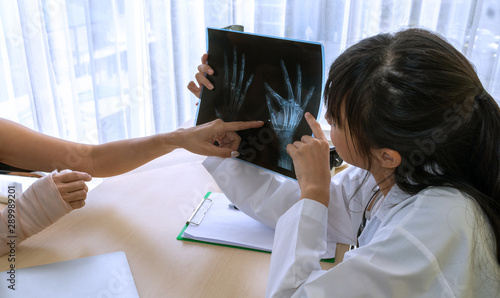 A doctor examining the hand and arm x-ray film Including the body at the hospital photo