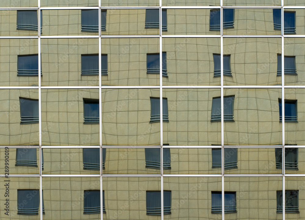 Mirror reflection of the facade of a multi-storey building in large mirrors. Mirror reflection of the facade of a multi-storey building in large mirrors.
