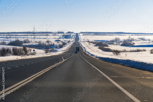 Winter road against a clear blue sky