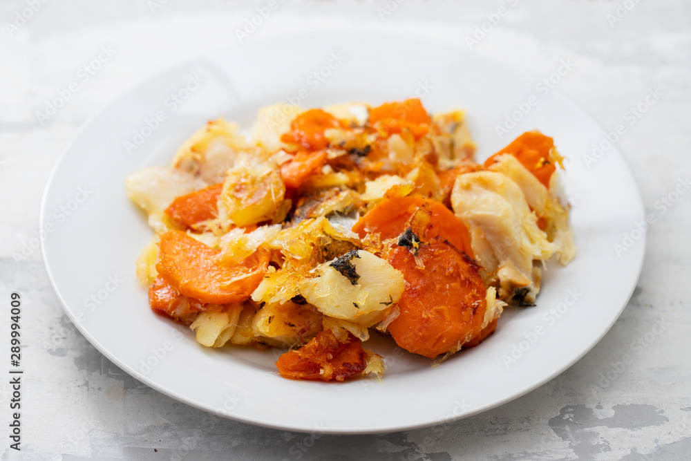 fried cod fish with sweet potato on white dish on ceramic background fried cod fish with sweet potato on white dish on ceramic background