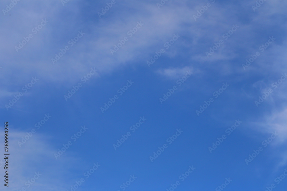 Blue sky with white clouds in the daytime background.