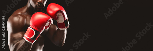 Cropped image of black boxer showing defending pose