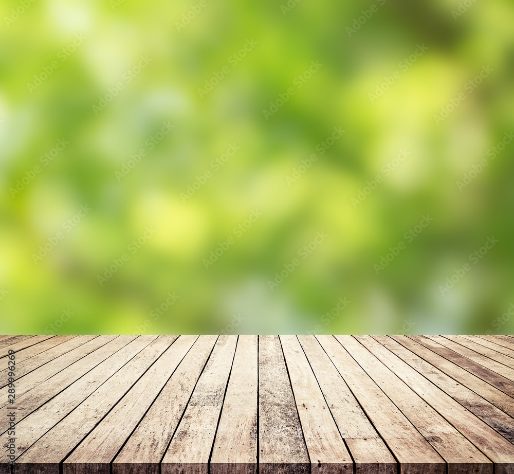 old wood plank with abstract green blurred background for product display old wood plank with abstract green blurred background for product display