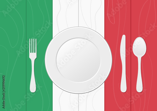 Fork, knife, spoon and plate over Italian flag on wood texture, green, white, red. Table setting for dinner. Italian cuisine concept. Cutlery, tableware, eating utensils. Place setting, arrangement. 