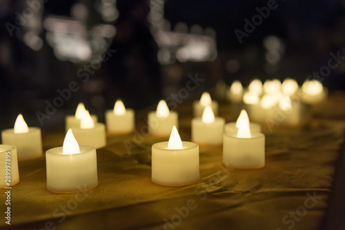 Festive blessing for environmentally friendly alternative use of white electronic candle close-up
