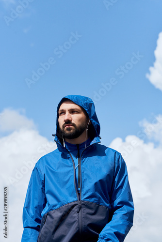 Outdoor portrait of sportsman in blue raincoat © sata_production