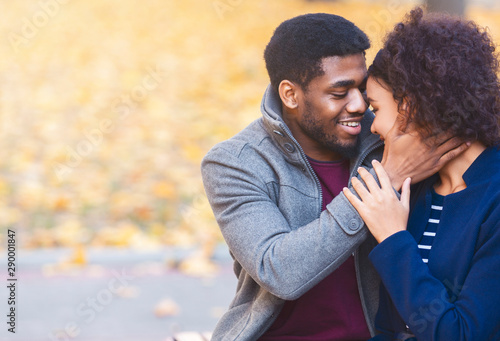 Loving black man holding his girlfriend face