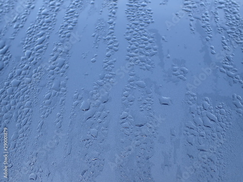 Drops of water on blue metal