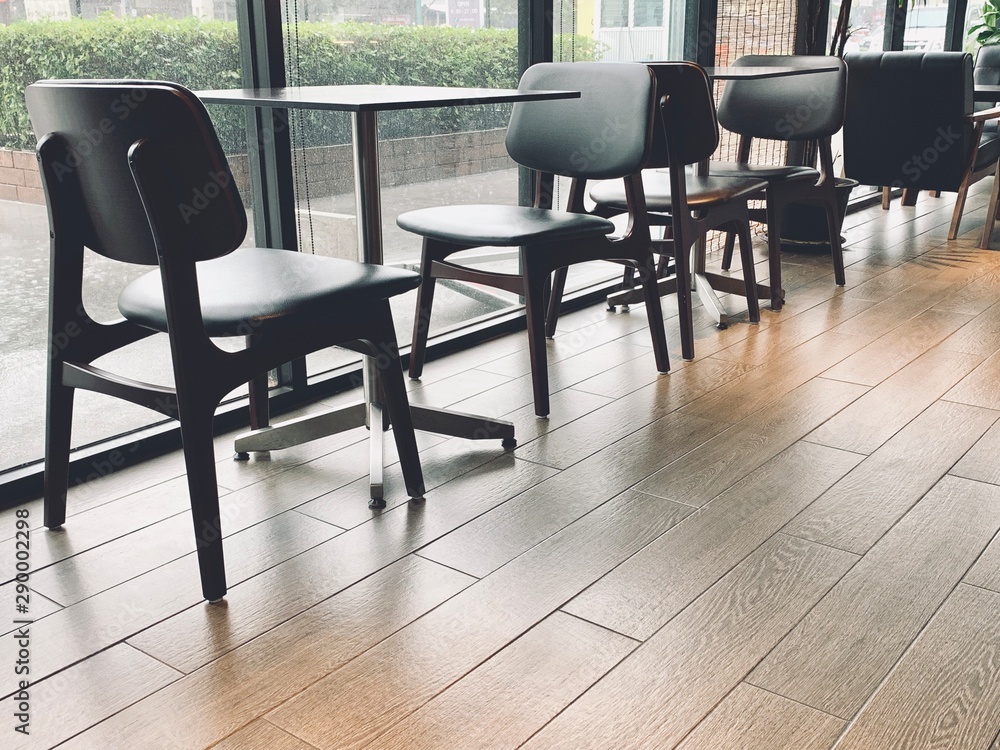table and chairs in cafe, interior of restaurant cafe with window glass and table with chair against brown color of floor tile