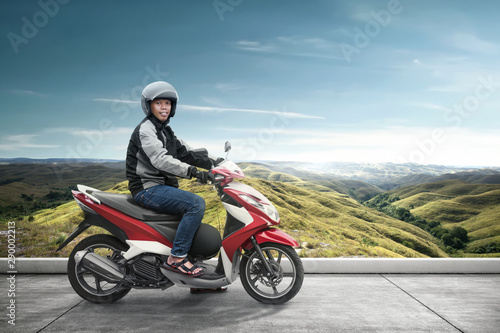 Asian motorcycle taxi man with his motorcycle