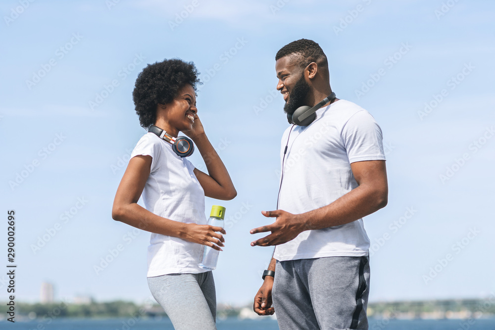 Man And Woman Talking After Morning Jog Near River Man And Woman Talking After Morning Jog Near River