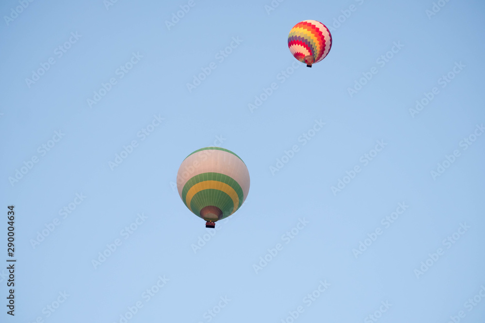 A giant balloon floats above Vang Vieng, Laos, with a bird's eye view of Vang Vieng and nature. A giant balloon floats above Vang Vieng, Laos, with a bird's eye view of Vang Vieng and nature.