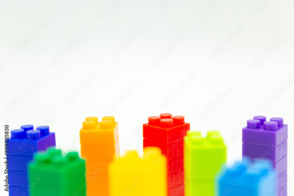 mini figures toy , cube brick background . construction tower building concept . mini figures toy , cube brick background . construction tower building concept .