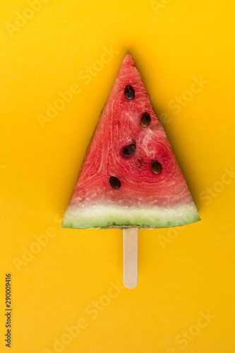 Watermelon slice on a ice cream stick.