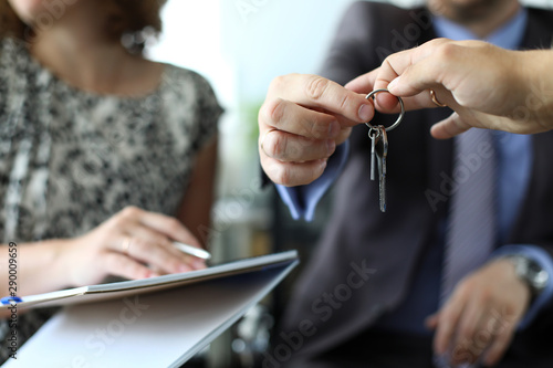 Fotografie Businessman giving house keys to new owner after signing profitable contract