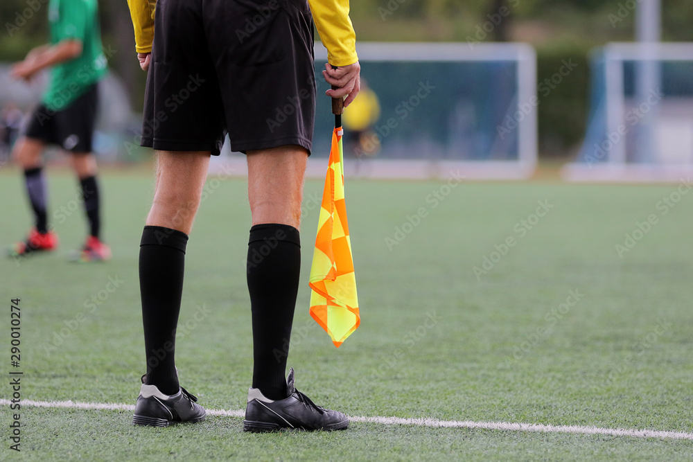 Obraz premium The line referee observes the situation on the football field