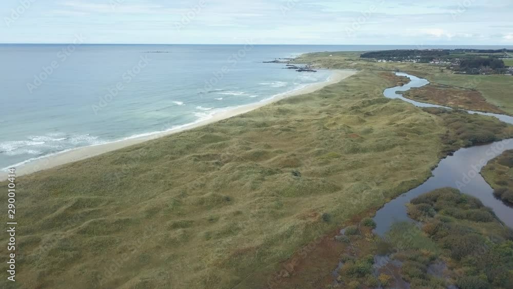 Drone shot of south west coast of Norway. Flying upwards and panning to the left over river and sandy beach. Atlantic Ocean horizon in background. Drone shot of south west coast of Norway. Flying upwards and panning to the left over river and sandy beach. Atlantic Ocean horizon in background.