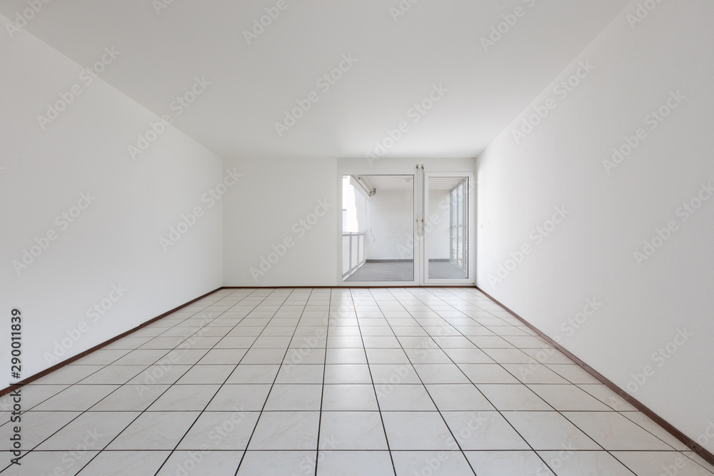 Front view of empty room with white walls and tiles Front view of empty room with white walls and tiles