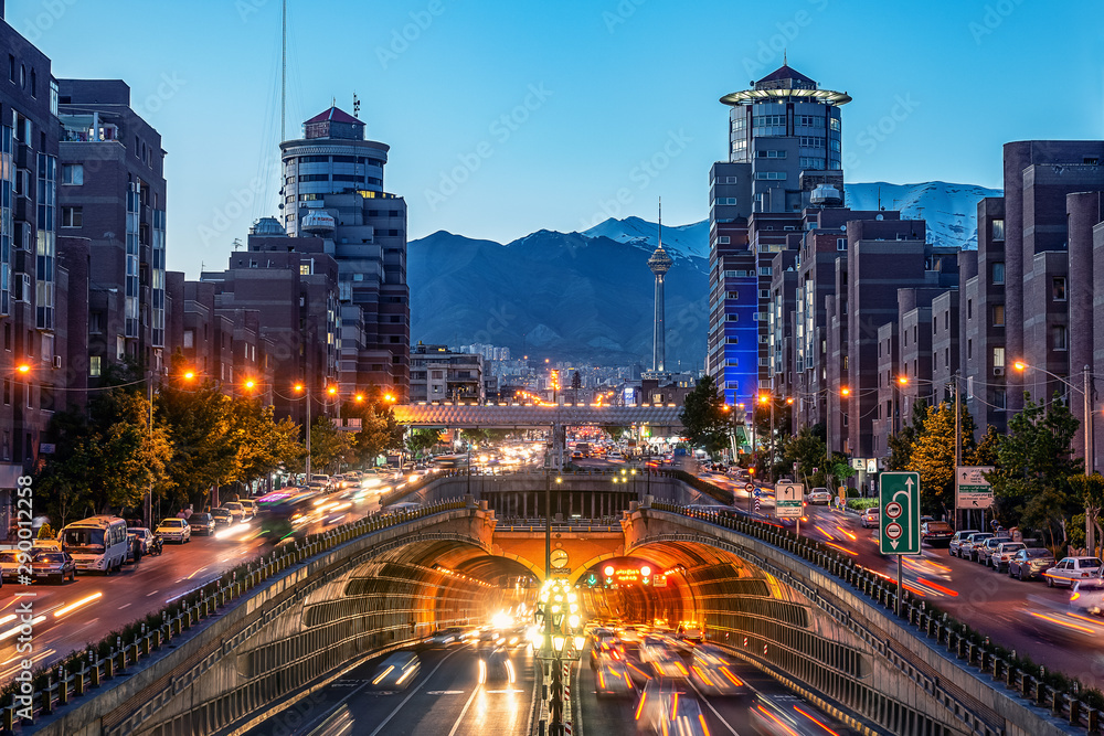 06/05/2019 Tehran,Iran,Famous night view of Tehran,Flow of traffic round Tohid Tunnel with Milad Tower and Alborz Mountains in Background, Tohid Tunnel one of longest urban tunnel in Middle East 06/05/2019 Tehran,Iran,Famous night view of Tehran,Flow of traffic round Tohid Tunnel with Milad Tower and Alborz Mountains in Background, Tohid Tunnel one of longest urban tunnel in Middle East