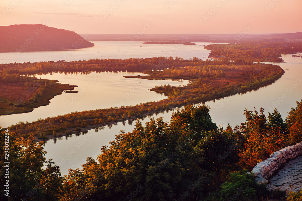 Evening view of the Volga River from an observation platform near Samara, pink sunset over the Zhigulev mountains.