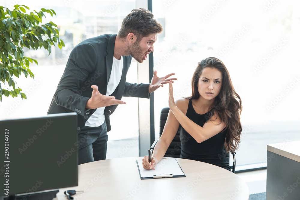 strict boss man swearing at employee woman for bad work at the office - obrazy, fototapety, plakaty 