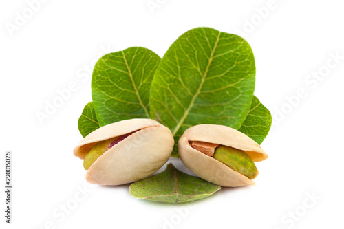 Several Tasty pistachio nuts with leaves isolated on white background