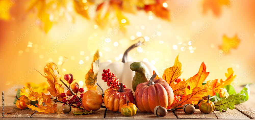Autumn background from fallen leaves and pumpkins on wooden vintage table. Autumn concept with red-yellow leaves background. Thanksgiving pumpkins. - obrazy, fototapety, plakaty 