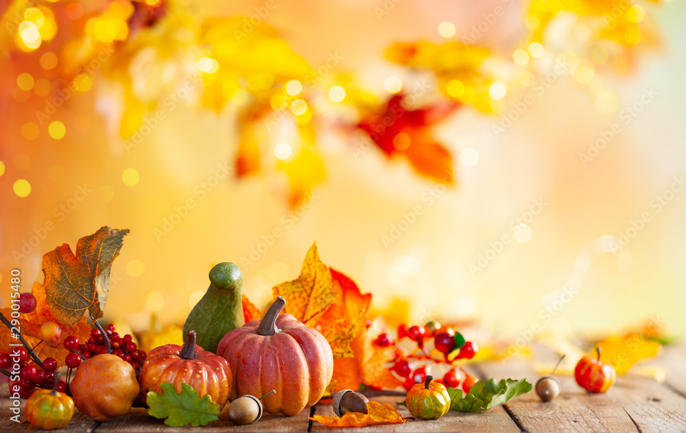 Autumn background from fallen leaves and pumpkins on wooden vintage table. Autumn concept with red-yellow leaves background. Thanksgiving pumpkins. - obrazy, fototapety, plakaty 