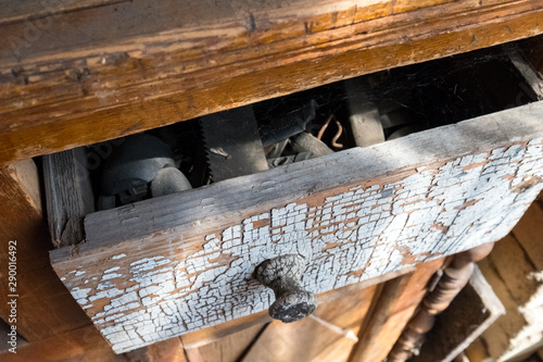 Ajar old toolbox. Wooden chest of drawers