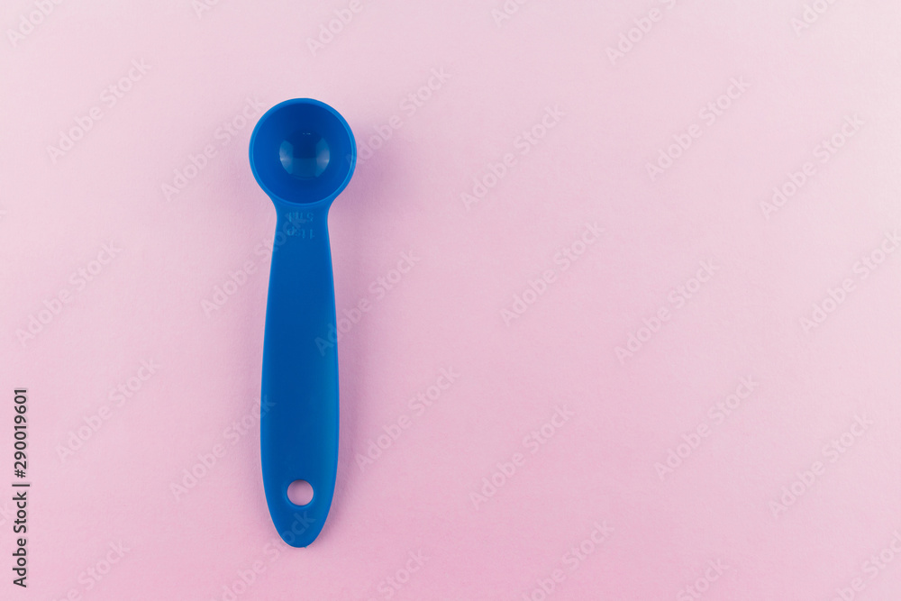 measuring spoon of plastic on pink background. measuring spoon of plastic on pink background.