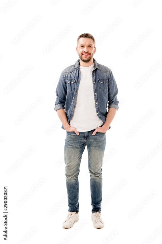 full length view of smiling bearded man in jeans standing with hands in pockets isolated on white full length view of smiling bearded man in jeans standing with hands in pockets isolated on white